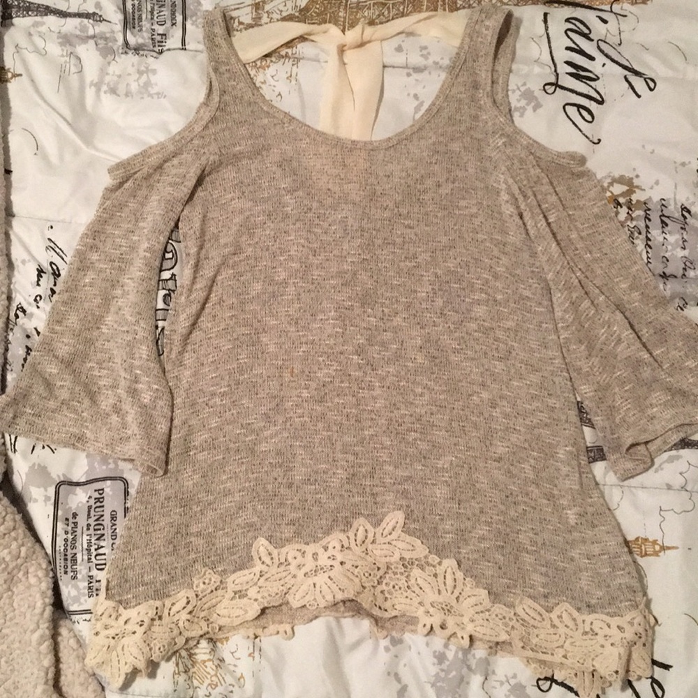 Cold shoulder sweater with lace and bow detail.